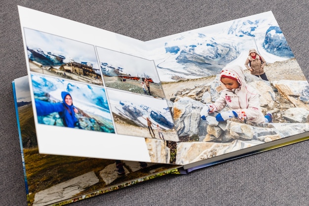 Photo the photobook opened, travel in switzerland, on gray background