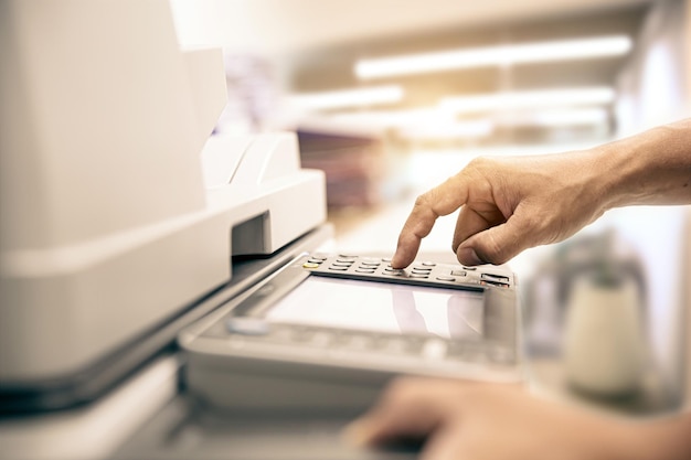 Photocopier printer Close up hand office man press copy button on panel to using the copier or photocopy machine for scanning document or printing paper or Xerox a sheet