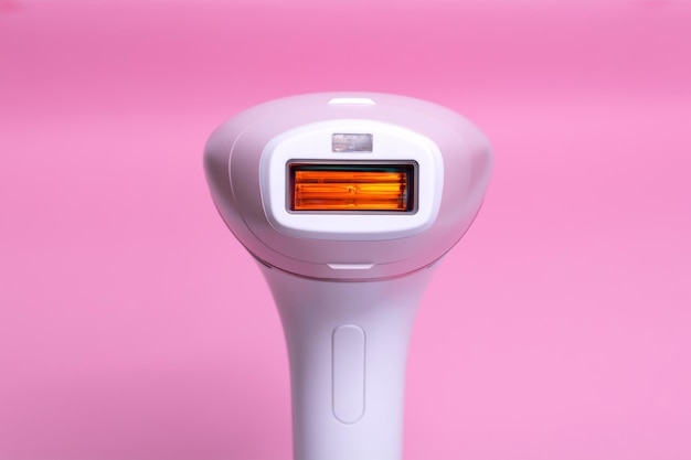 분홍색 배경에 Photoepilator 제모 도구