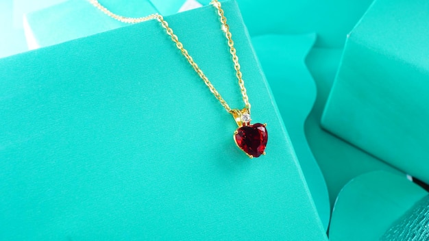 A photograph of a gold necklace on a blue background