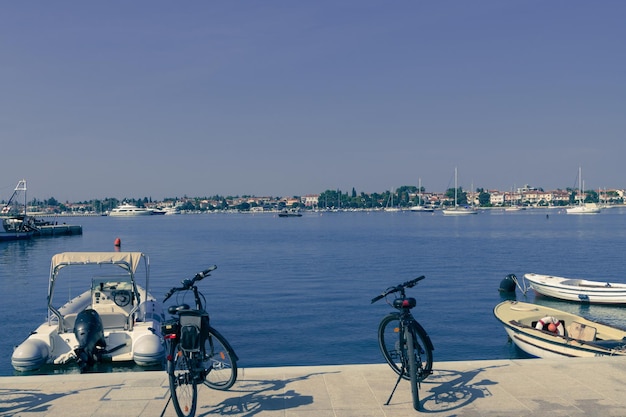 A photograph of a ship and a luxury yacht anchored in port beautiful photo of a mediterranean port