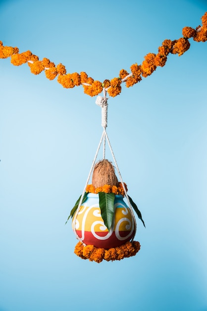 photograph of traditional dahi handi or matka (earthen pot) tied up high on gokulashtami festival which is lord shri krishna's birth day