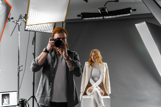 Photographer and fashion model in studio for creative art clothes brand and designer social media