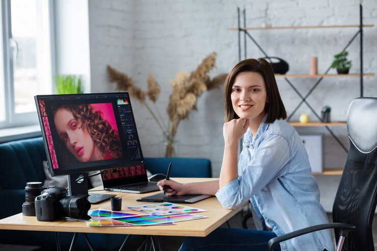 Photo photographer and graphic designer working in office with laptop, monitor, graphic drawing tablet and color palette.