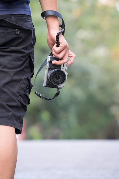 photographer holding camera, close-up. Back view, Selective focus