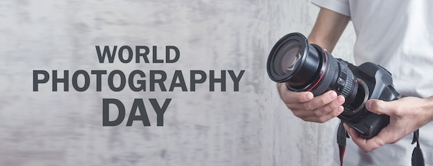 Photographer holding camera. World Photography Day