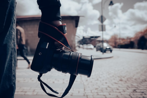 The photographer holds the camera in his hand