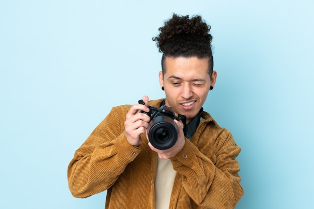 Photographer man over isolated blue background