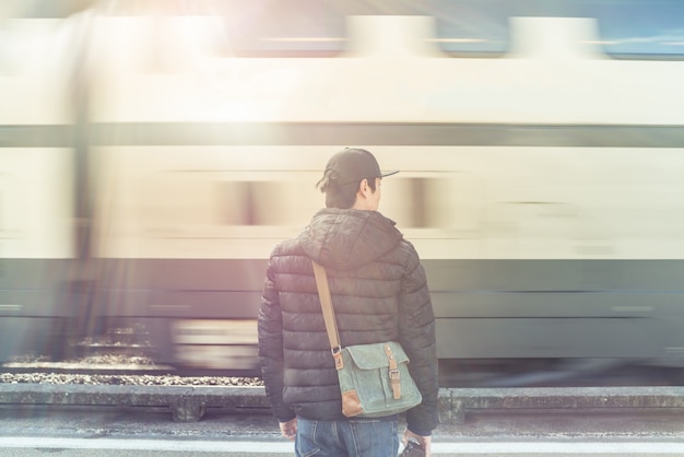 Photographer man standing by moving train