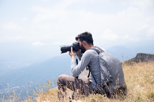 Photographer on mountain Nature photographer taking photo