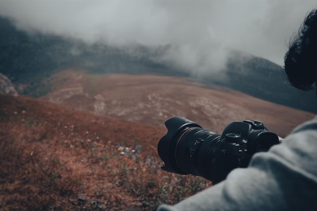 The photographer on the mountain takes a photo