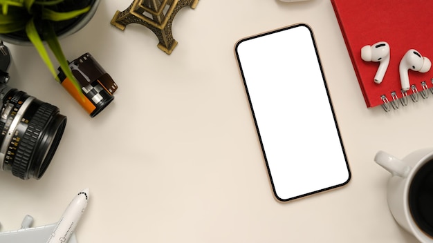 Photographer office desk with smartphone white screen mockup and copy space on white background