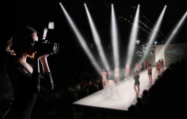 Photographer Press Woman use Camera to shoots Photo of Fashion Week Show which Model Supermodel walk on Runway Catwalk for New collection of designer brand, background copy space