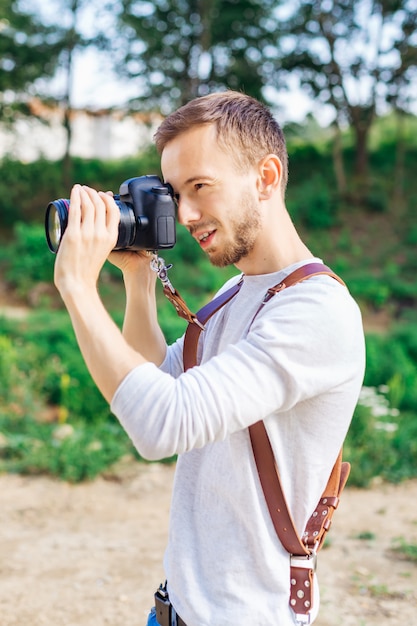 Photographer during a professional activity at the background of the park