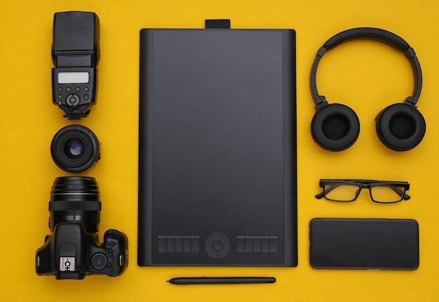 Photographer retouching equipment on a yellow background. Top view. Flat lay