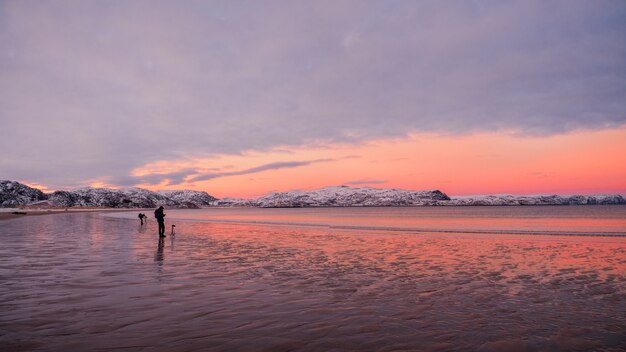 The photographer shoots a wonderful Arctic sunset landscape on the Barents sea.