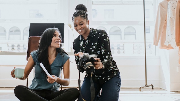 Photographer showing her collection to the designer