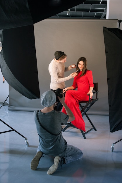 Photographer and stylist work in studio 