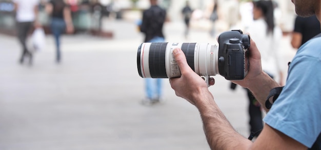 Photographer takes photographs with dslr camera in a city