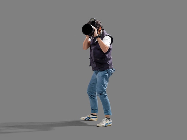 Photographer taking photo on digital camera isolated on gray background