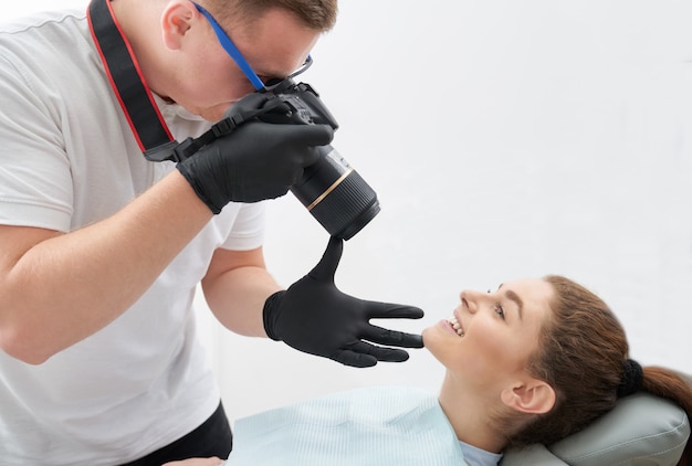 Photographer taking photo of woman smiling in dentistry.