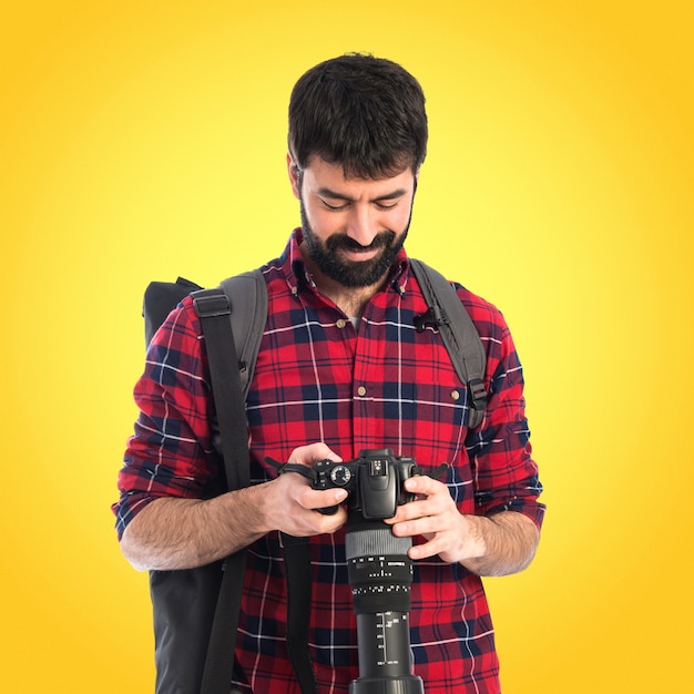 Photographer over white background on colorful background