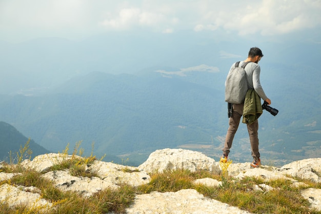 Photographer with backpack and digital camera in nature Travel Active lifestyle