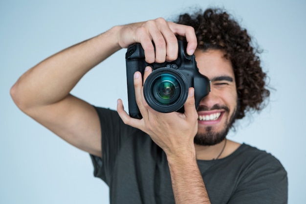 Photographer with digital camera in studio