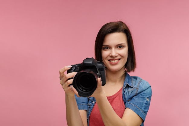 Photographer with professional camera taking photo in photo studio