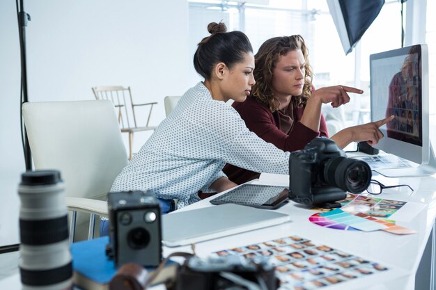 Photographers working over computer