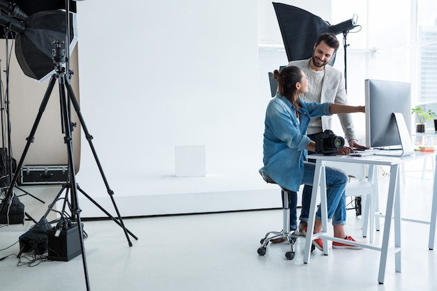 Photographers working together over computer