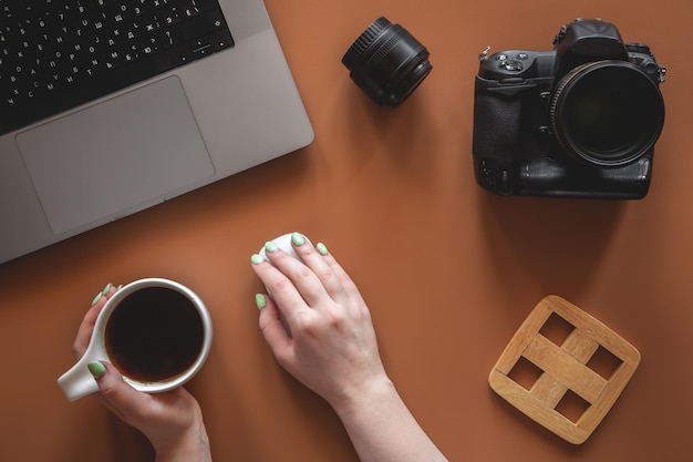 Photographers workplace with camera and lens flat lay