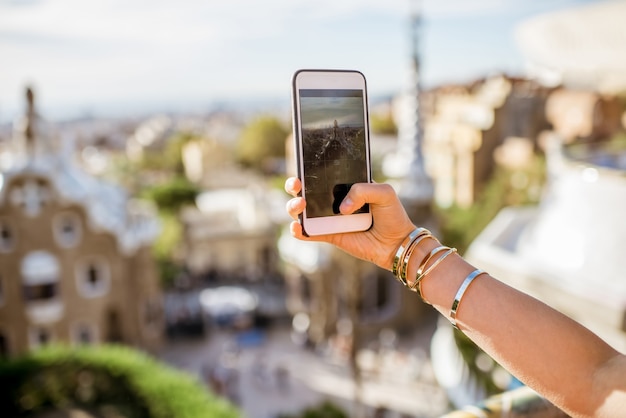 Photographing with phone Guell park in Barcelona city