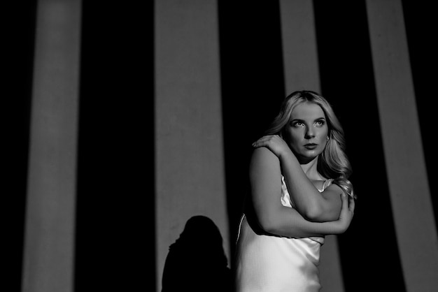 Photographing with Projectors , black and white , light and dark, with the figure of a beautiful girl posing, fashionable toning.