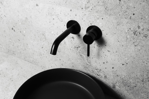 Photography of bathroom details black washbasin and mounted tap