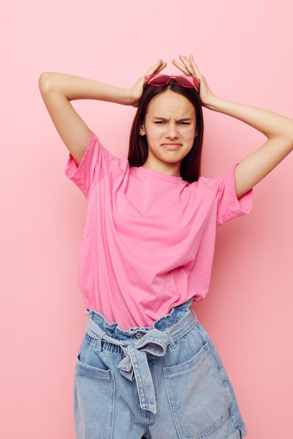 Photography pretty woman in a pink tshirt casual clothes pink background