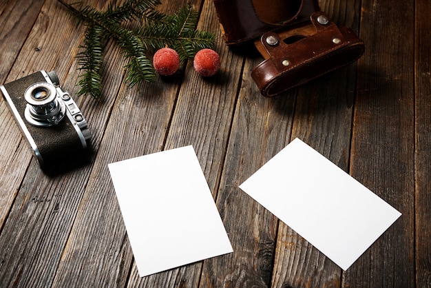 Photos, camera, pine tree branch and cup of coffee