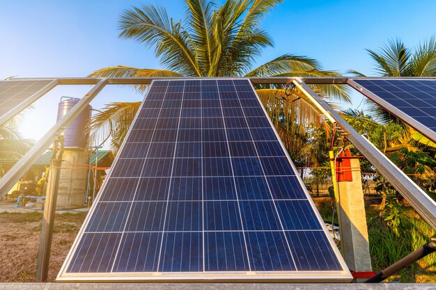 Photovoltaic solar power panel for agriculture in a rural houses area Agricultural fields blue sky backgroundAgroindustry of household Rural style in Thailand smart farm alternative clean energy