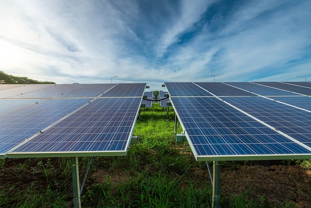 Photovoltaic solar power panel on dramatic sunset blue sky background green clean Alternative power energy concept