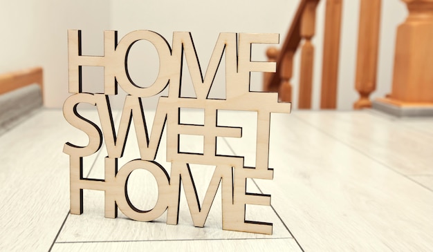 Photo phrase home, sweet home made of wood on of new house