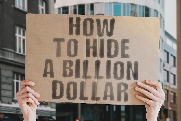 The phrase How to hide a billion dollar on a banner in mens hand Law Tax Taxation Corruptible