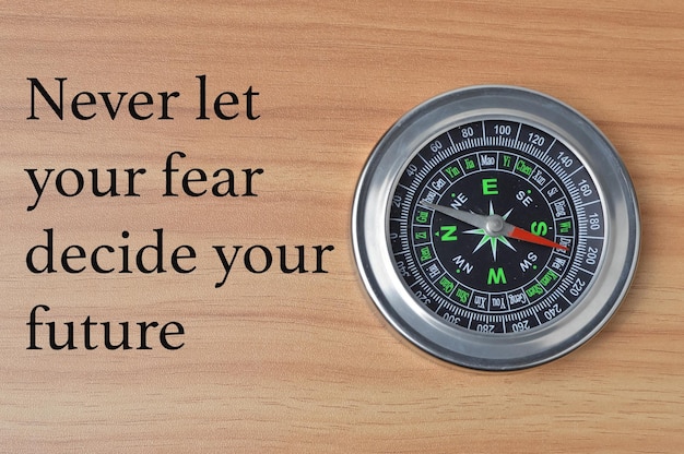 Phrase NEVER LET YOUR FEAR DECIDE YOUR FUTURE Motivational quote