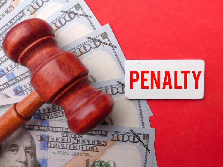 Photo phrase penalty written on wooden board with gavel and fake money law concept