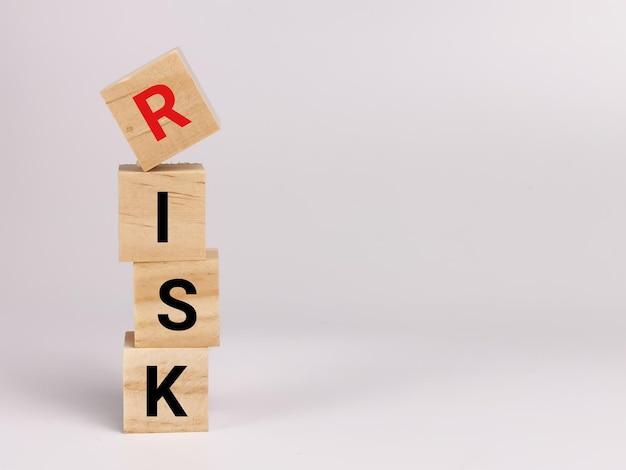 Phrase RISK on wooden cubes isolated on white background.Business concept.