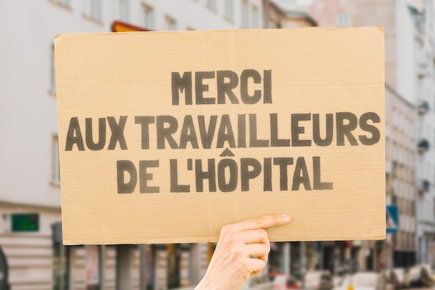 The phrase Thank you hospital workers on a banner in hand The Human holds cardboard with an inscription Gratitude to healthcare staff Heroes People who save lives Thankfulness Life