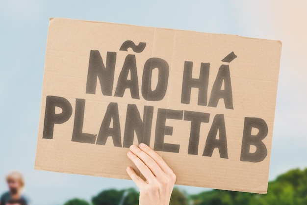 The phrase There is no planet B is drawn on a carton banner in men's hands Climate change Protest Global warming Zone Disaster Tension Poison Toxin Damage Impact Air