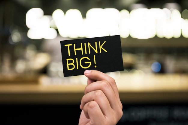 Phrase Think big written on a card