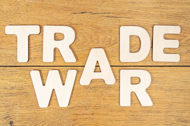 phrase - trade war, laid out in wooden letters on an old wooden table