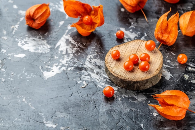 Physalis on wooden stump Ripe berries of autumn red physalis fruit berries fruit Physalis or Chinese Lantern Plants