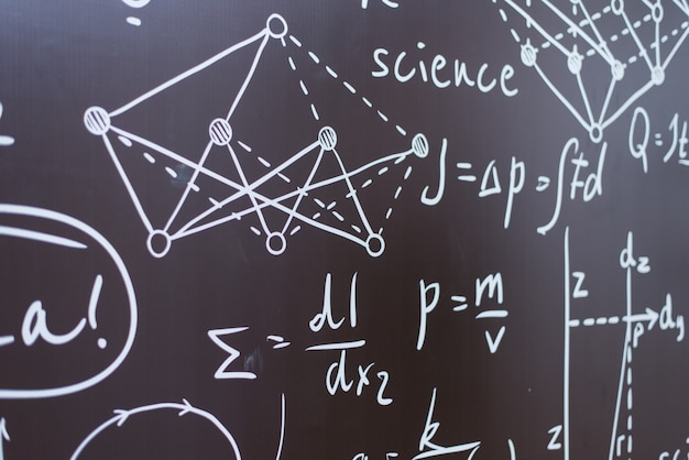 Physical and chemical formulas and graphs on a black school board